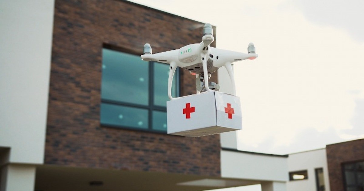 Delivery drone carrying a medical package hovering beside a residential building, illustrating drone port zoning and the split between local land use control and FAA airspace authority